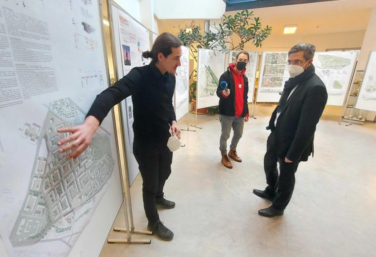 Andre Schwarz von der Stadtverwaltung zeigt Oberbürgermeister Mike Schubert Plakate mit Entwürfen für den Stadtteil Schlaatz.